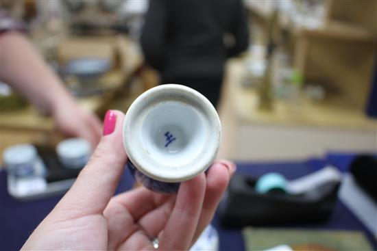 A Chinese blue and white tea bowl and saucer and two jars, Kangxi, some damage, largest diameter 11cm